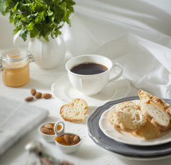 Cup of tea with biscuits and apricot jam