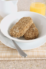 Whole wheat breakfast cereal served with milk and juice