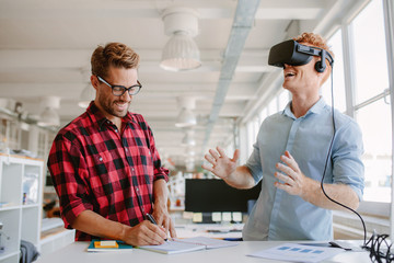 Developers testing virtual reality glasses in office - obrazy, fototapety, plakaty