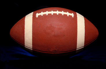 American Football close up on black background