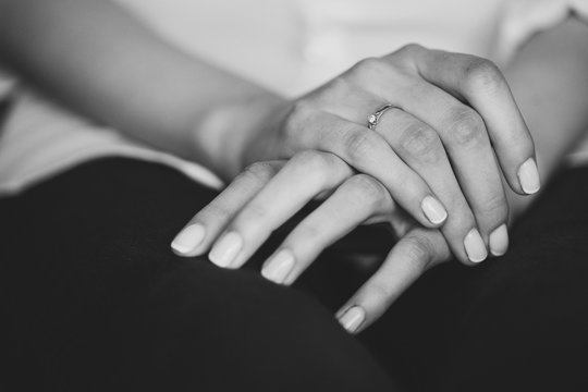 Engagement ring on young girl's finger. Black and white image.