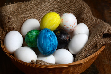 Set of Colorful Easter Eggs in Basket with Jute