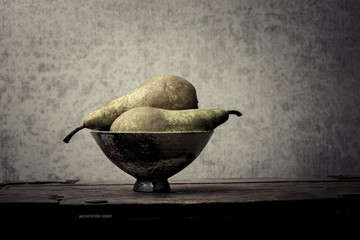 Fruit still life with pears on wooden table. Vintage rustic food image with artistic texture effect.
