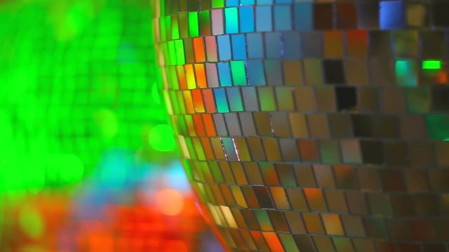 bright multi colored rays of light reflected from the disco ball