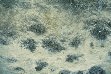 Empty stone wall with damage and cracks. Old grungy building with nice weathered texture. Background with copy space.