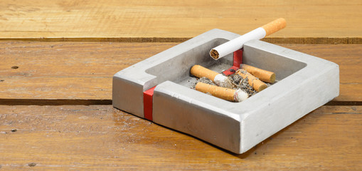 cigarette and ashtray on table