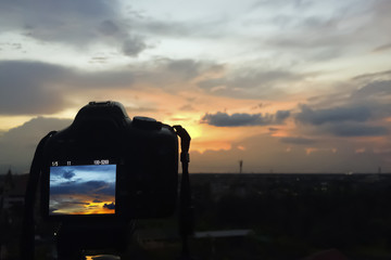 Fototapeta na wymiar Shooting the beautiful Sunset Sky.Focus on camera.