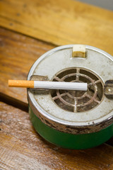 cigarette and ashtray on wood table