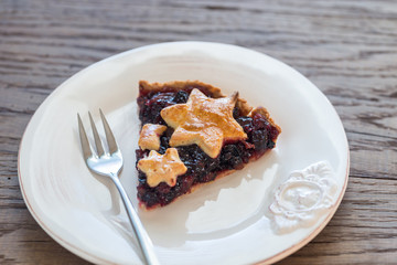 Portion of mince pie on the wooden background