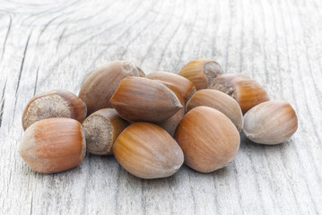Hazelnuts on wooden table, fruit of hazel (Corylus avellana)