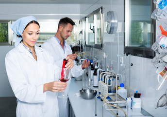experts making tests in winery laboratory.