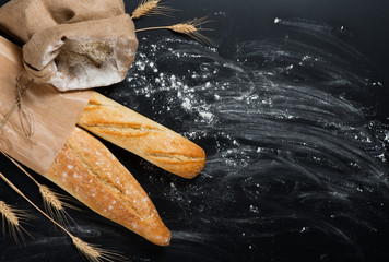 Baguettes bread, flour and wheat spikes. Above view.