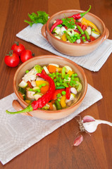 Hot vegetable soup on wooden table