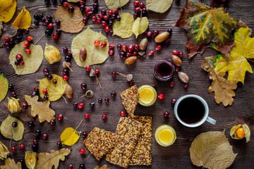 Autumn still life with honey and berries on wooden background