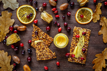 Autumn still life with honey and berries on wooden background