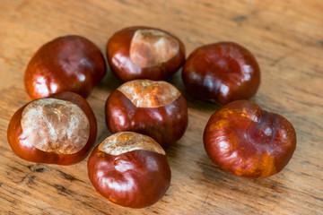 Fresh chestnuts on a rustic wooden background