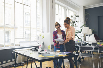 Two women working together in office