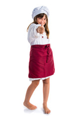 Little cute girl dressed like a chef with thumb up