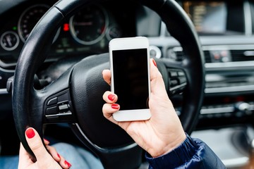 Woman holding a white smartphone with blank screen