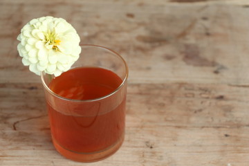Hot tea, flower on wood table.