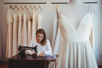 Female dressmaker sewing in the studio
