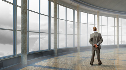Fototapeta premium Pensive businessman in office . Mixed media