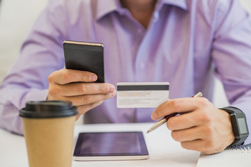 Businessman using a credit card and digital tablet for buying on line