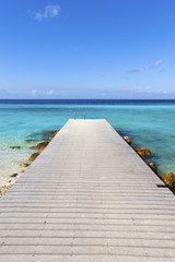 Jetty at the Caribbean sea leading into turquoise water