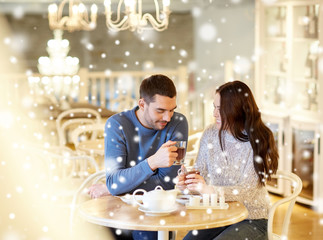 happy couple drinking tea at cafe
