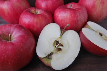 Ripe fresh red apples with a halved apple