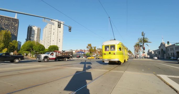 SAN FRANCISCO, CA - Circa October, 2016 - A yellow streetcar passes by on The Embarcadero in downtown San Francisco.	 	