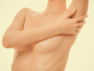 Woman examining her breasts for breast cancer