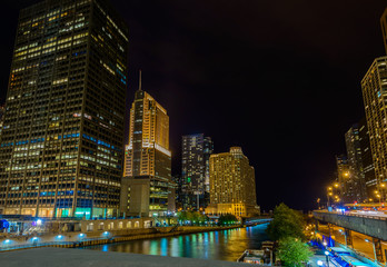 Chicago River skyline with urban skyscrapers at night, IL, USA