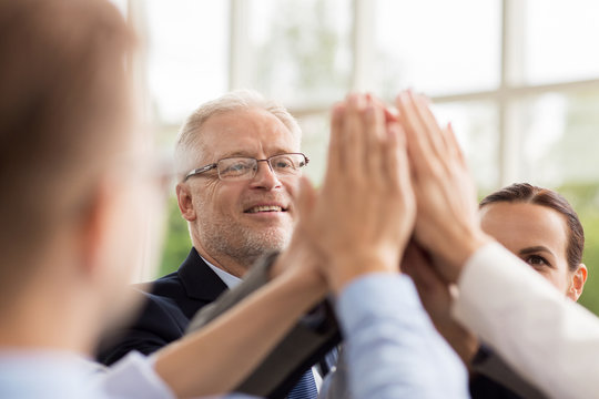 Business People Making High Five In Office