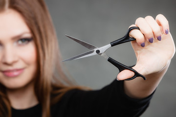 Professional hairdresser with scissors ready to cut.