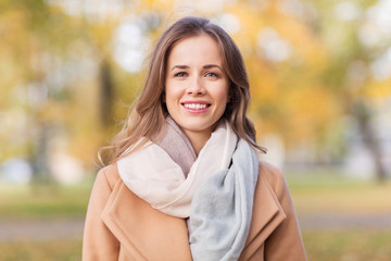 beautiful happy young woman smiling in autumn park