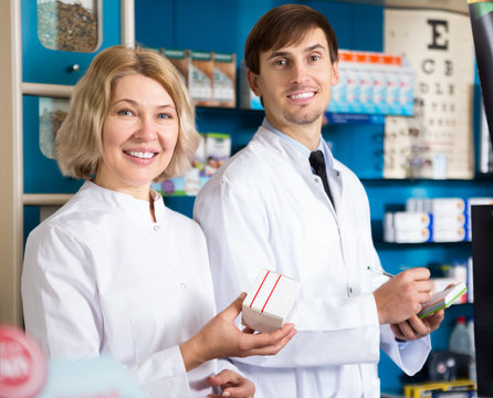 Two Pharmacists Posing In Drugstore