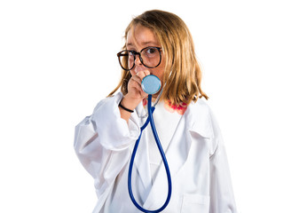 Little girl playing to be a doctor and holding a otoscope