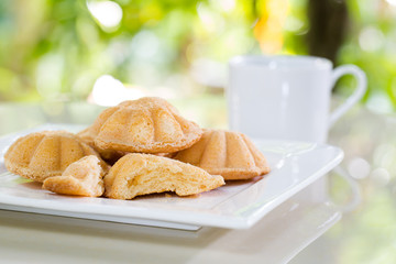 Egg cake, delicious dessert and black coffee in white dish on ti