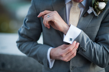 groom adjusting cuffs