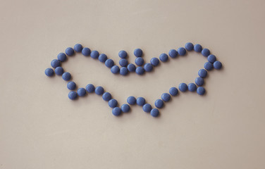 Halloween Holiday scary fly bat or flittermouse made of round small chocolate color candy. Isolate on white background.