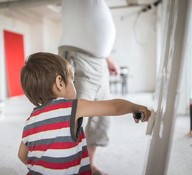 Little cute boy painting on a wall