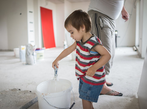 Little cute boy painting on a wall