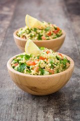 Tabbouleh salad with couscous on rustic wooden table

