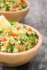Tabbouleh salad with couscous on rustic wooden table

