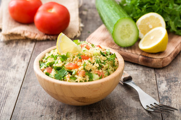 Tabbouleh salad with couscous on rustic wooden table

