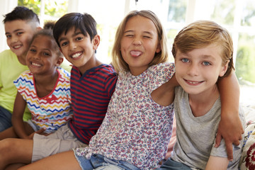 Group Of Multi-Cultural Children On Window Seat Together