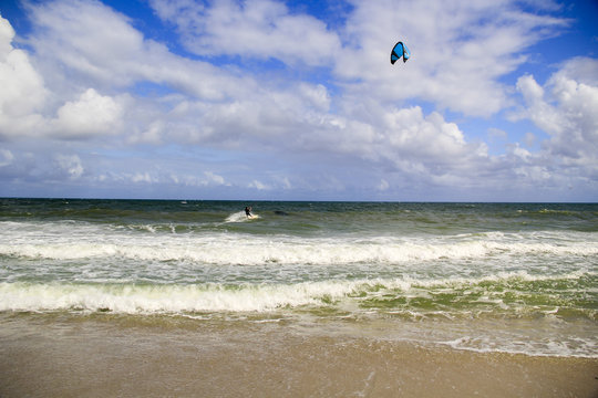 Kite surfer riding the huge waves created by Hurricane Matthew and Hurricane Nicole