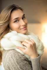Beautiful young woman wearing merino wool pastel colors scarf