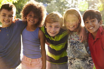 Portrait Of Five Children Having Fun Outdoors Together